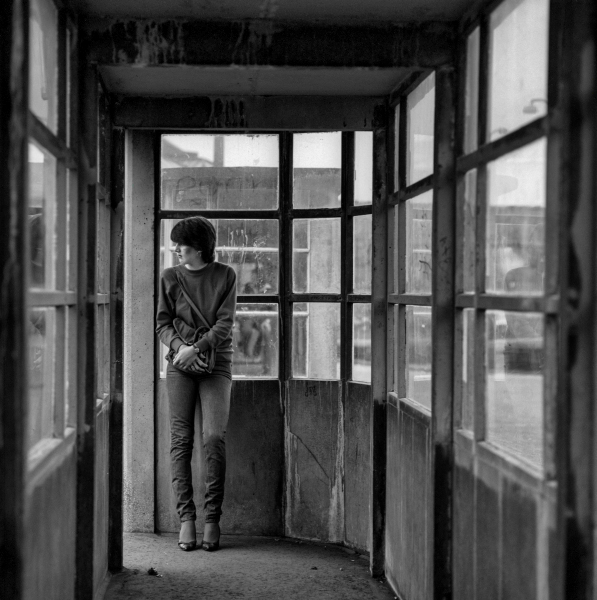 Girl waiting for bus in concrete shelter at Boulevard, Blackburn 1981