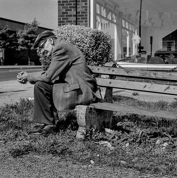 Old man, seated by road, Penny Street, leading from Town Centre