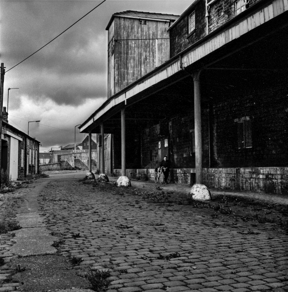 Cyclist Industrial Buildings off Higher Eanham, Near Leeds and Liverpool Canal, Blackburn 