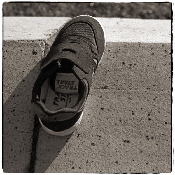 Shoe left on wall - from Discarded a Photographic Essay by Christopher John Ball Photographer and Writer